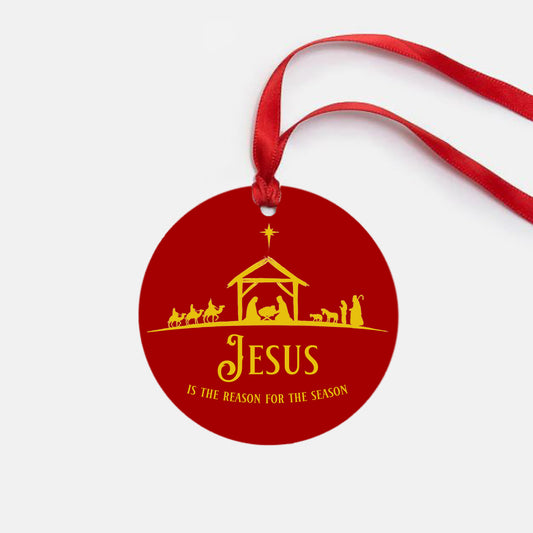 Red Christmas ornament with nativity scene and 'Jesus is the Reason for the Season' text on a white background.